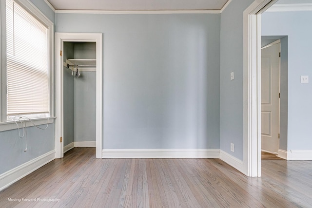 interior space featuring light wood-type flooring and crown molding