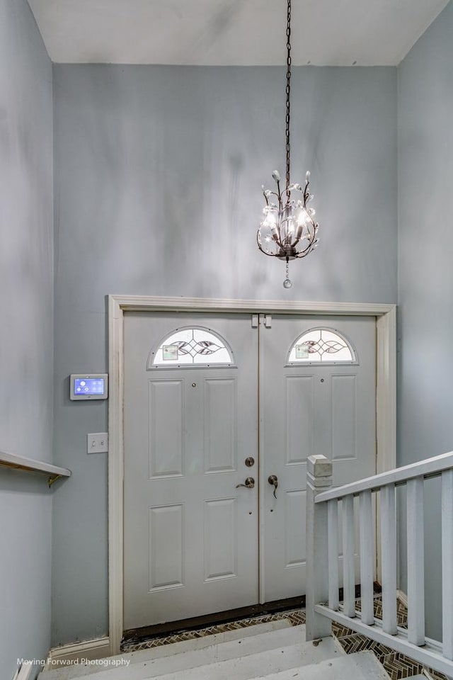 entryway featuring light hardwood / wood-style flooring and a notable chandelier