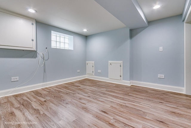 basement with light hardwood / wood-style floors