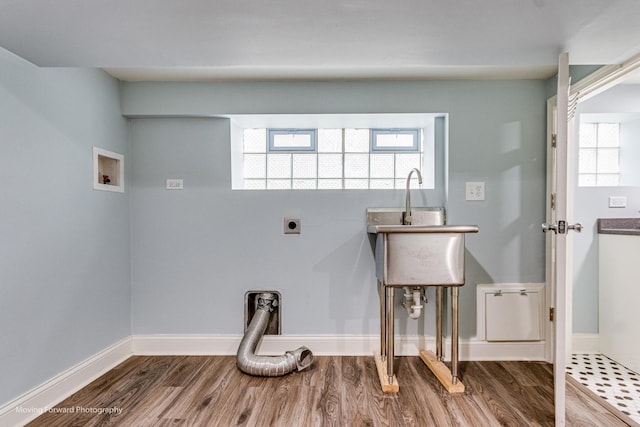 clothes washing area with electric dryer hookup, hardwood / wood-style floors, and washer hookup