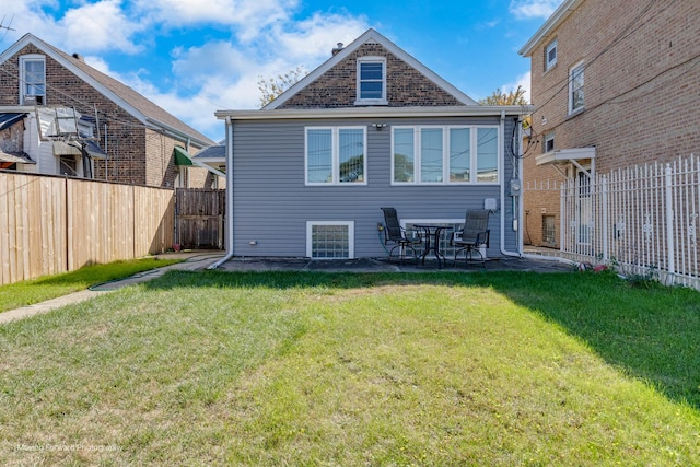 rear view of house featuring a lawn