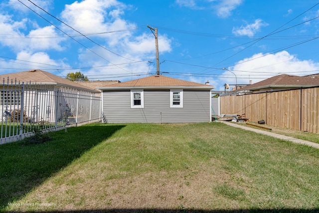 rear view of house featuring a lawn