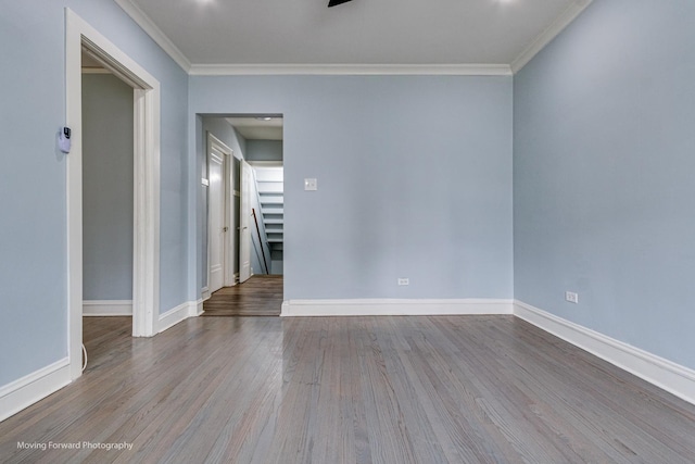 spare room with light hardwood / wood-style floors and crown molding