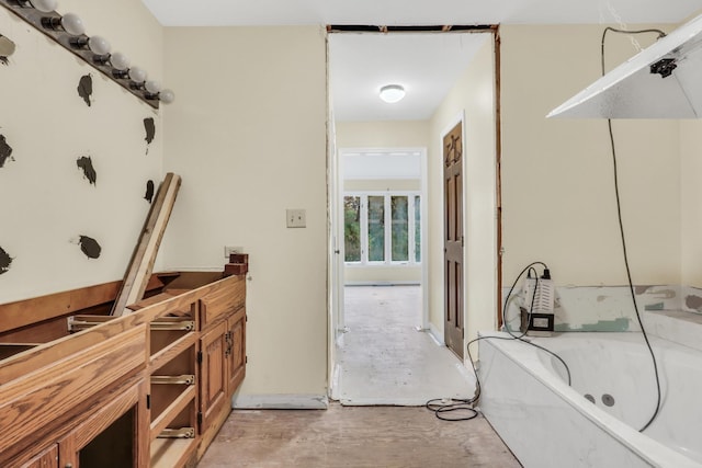 bathroom featuring concrete floors and a bathing tub