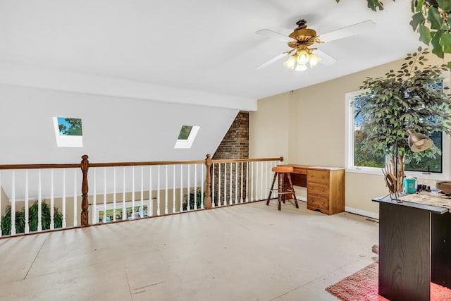 bonus room with lofted ceiling with skylight and ceiling fan