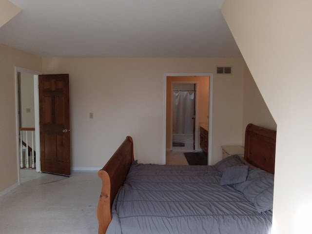 bedroom featuring ensuite bath and a walk in closet