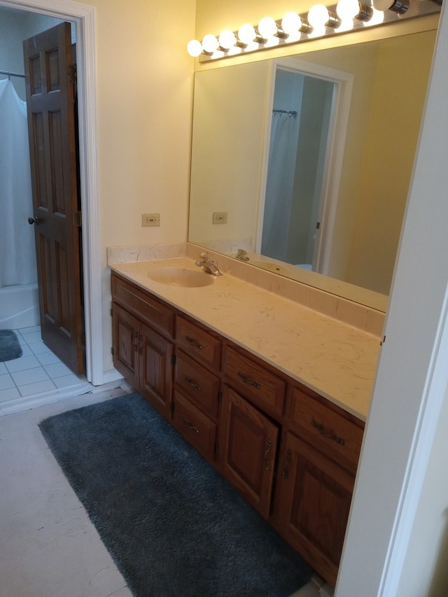 bathroom with tile patterned flooring, vanity, and curtained shower