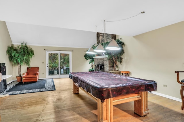 game room featuring a brick fireplace, wood-type flooring, and pool table