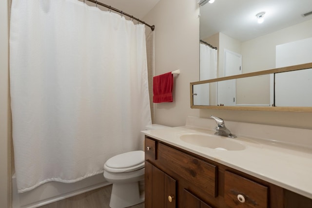 bathroom with hardwood / wood-style floors, vanity, and toilet