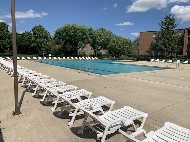 view of swimming pool featuring a patio area