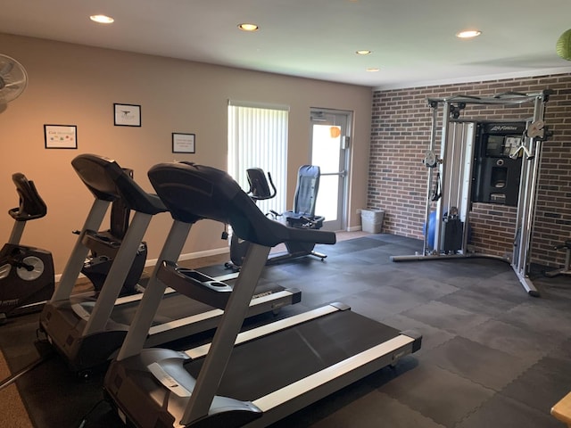 gym featuring brick wall