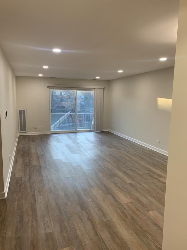 spare room featuring dark wood-type flooring