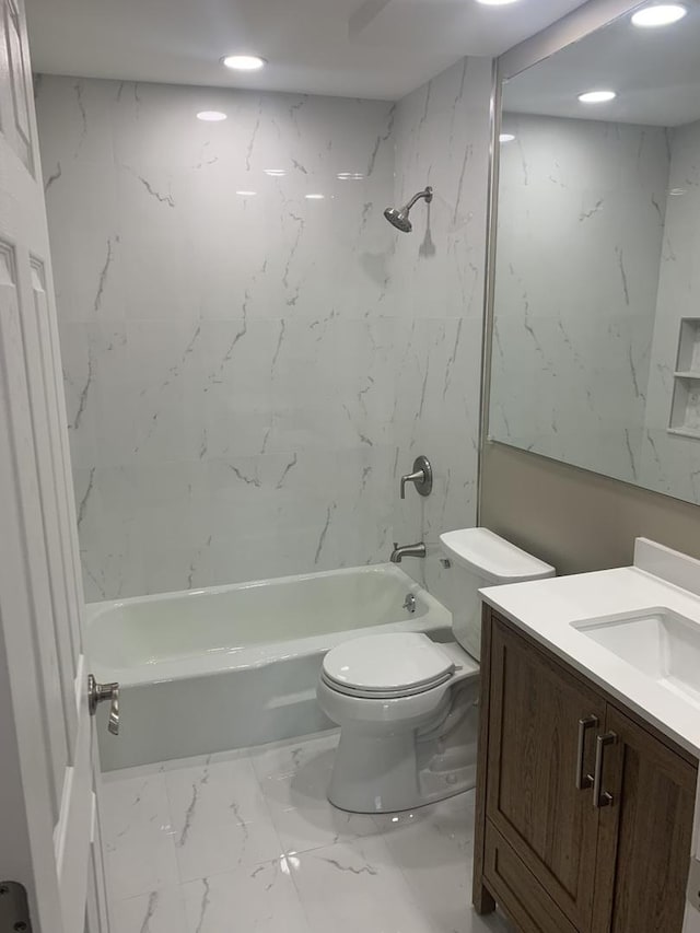 full bathroom with vanity, toilet, and tiled shower / bath combo