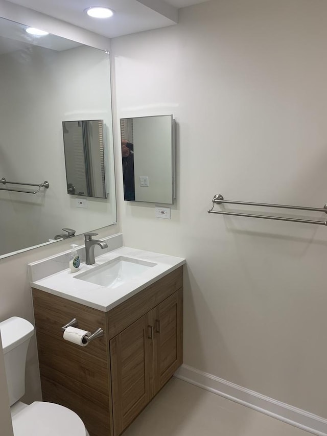 bathroom featuring vanity and toilet