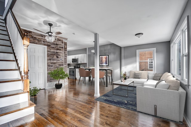 living room featuring ceiling fan and dark hardwood / wood-style flooring