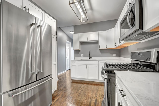 kitchen with sink, white cabinetry, dark wood-type flooring, and appliances with stainless steel finishes