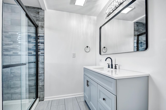 bathroom featuring vanity and a shower with door