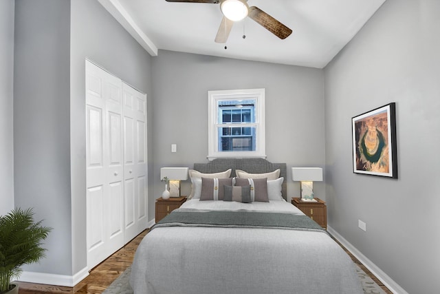 bedroom with a closet, vaulted ceiling, ceiling fan, and dark wood-type flooring