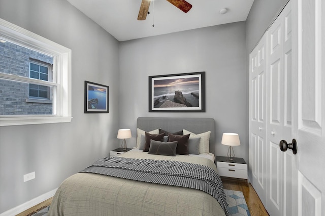 bedroom with hardwood / wood-style floors, a closet, and ceiling fan