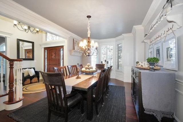 dining space featuring dark hardwood / wood-style floors, ornamental molding, and an inviting chandelier