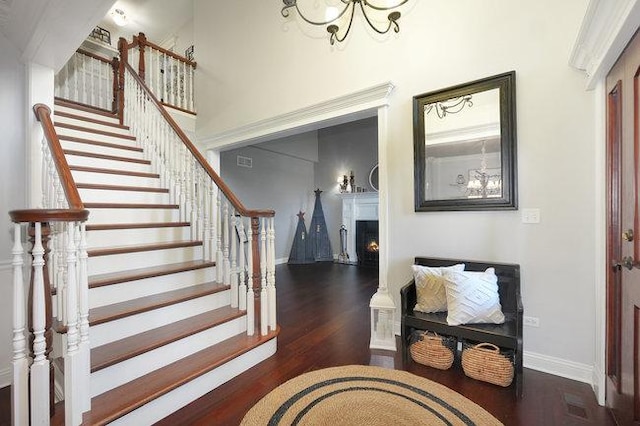 entryway featuring a notable chandelier and dark wood-type flooring