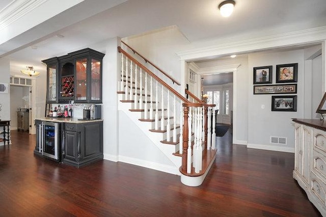 bar featuring dark hardwood / wood-style floors, wine cooler, and ornamental molding