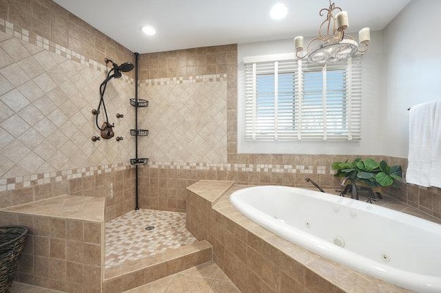 bathroom with tile patterned flooring, shower with separate bathtub, and a chandelier