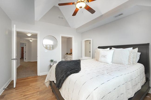 bedroom with ceiling fan, wood-type flooring, and lofted ceiling