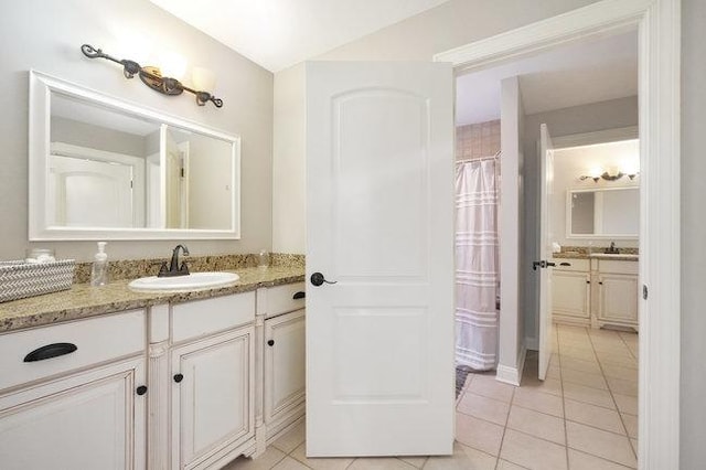 bathroom featuring tile patterned flooring and vanity