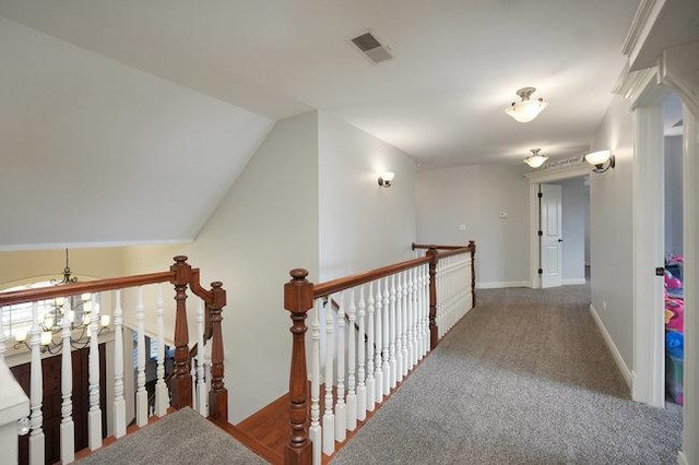 corridor with carpet floors and lofted ceiling