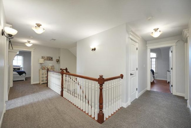 corridor featuring carpet floors and vaulted ceiling