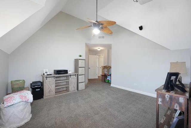 interior space with ceiling fan, vaulted ceiling, and dark colored carpet