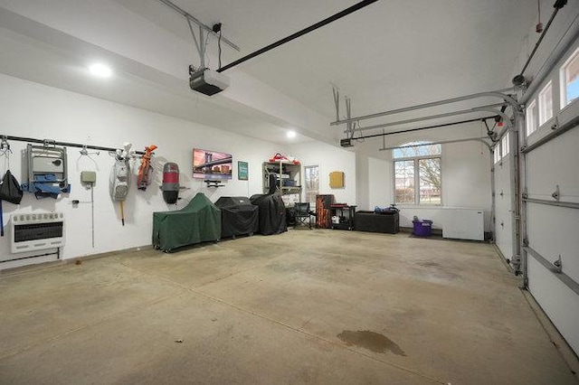 garage with a garage door opener and heating unit