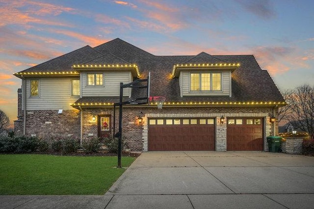 view of front of property with a lawn and a garage