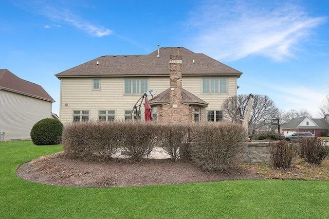 rear view of property featuring a yard