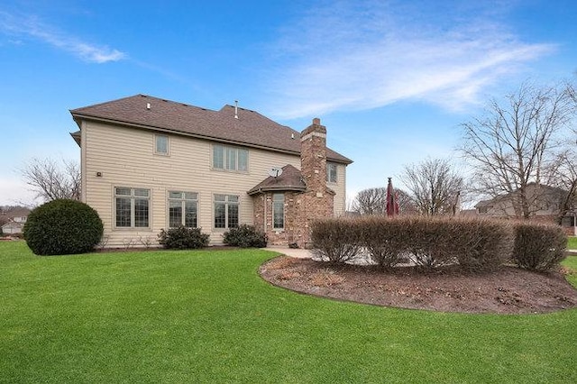 rear view of property featuring a lawn