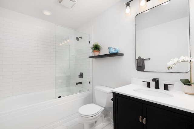 full bathroom with shower / bath combination with glass door, tile patterned floors, vanity, and toilet