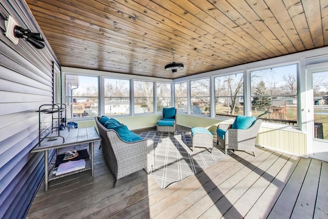 sunroom / solarium featuring a healthy amount of sunlight and wood ceiling