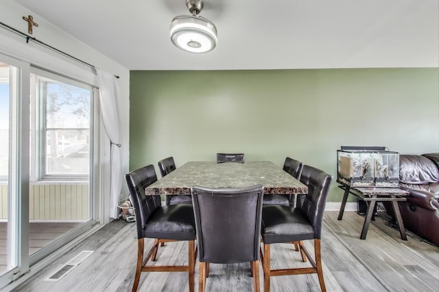 dining space with light hardwood / wood-style flooring