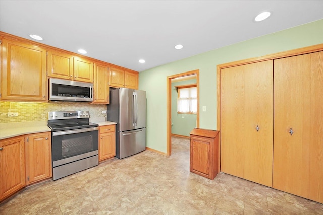 kitchen featuring stainless steel appliances and tasteful backsplash