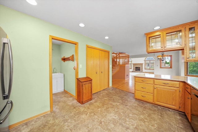 kitchen featuring stainless steel fridge and a notable chandelier