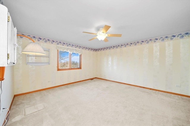 empty room with ceiling fan and light carpet