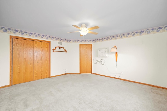 unfurnished bedroom with carpet flooring, ceiling fan, and a closet