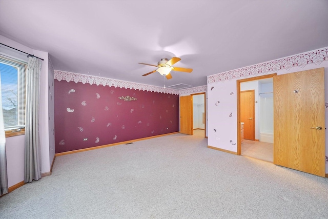 unfurnished bedroom featuring carpet flooring, ceiling fan, and ensuite bathroom