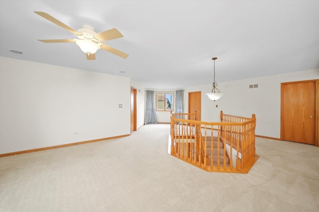 carpeted empty room featuring ceiling fan