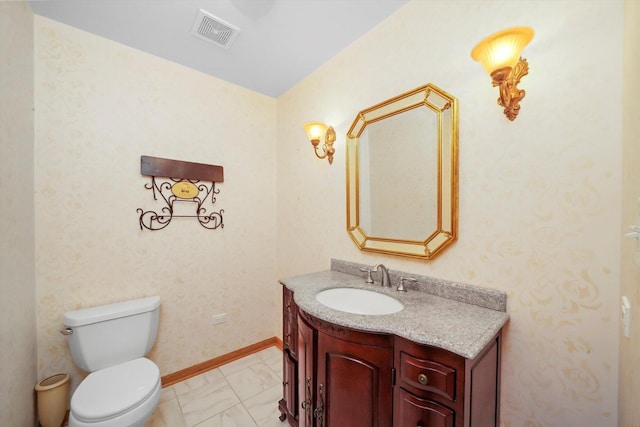 bathroom featuring vanity and toilet