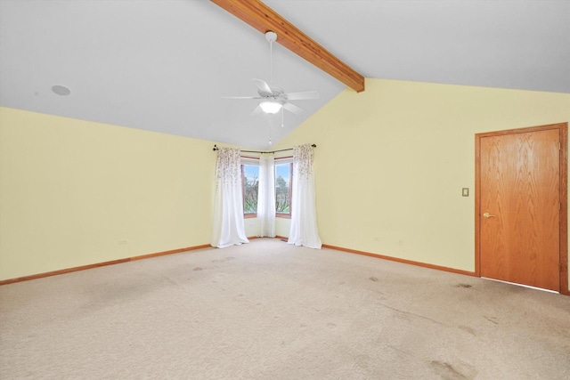 carpeted empty room featuring ceiling fan and lofted ceiling with beams