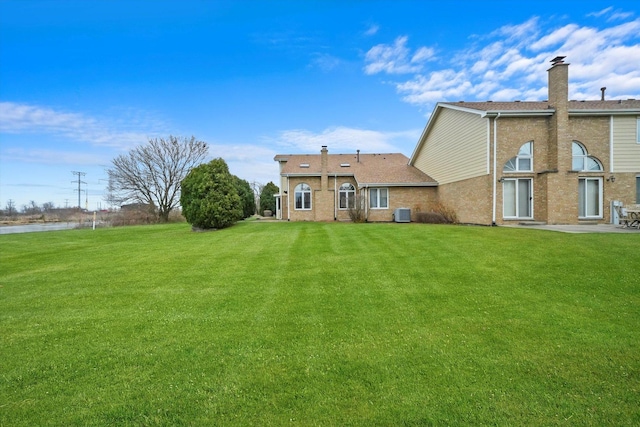 rear view of house featuring a yard