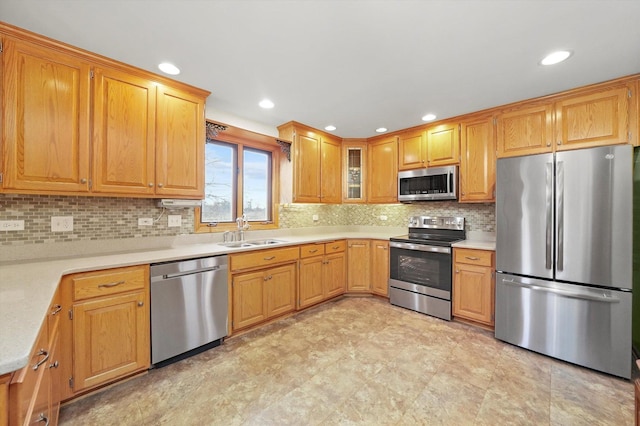 kitchen with stainless steel appliances, tasteful backsplash, and sink