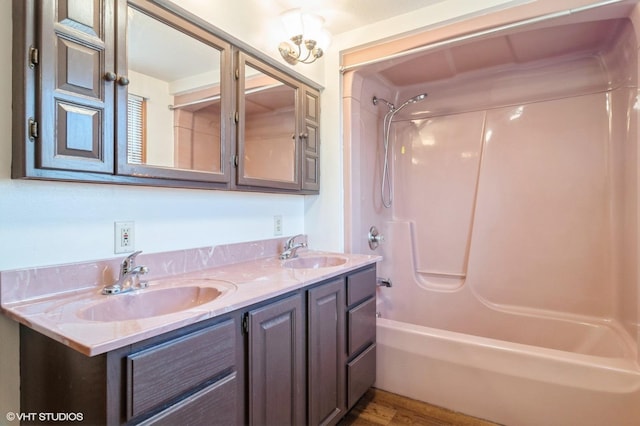 bathroom featuring vanity, shower / bath combination, and wood-type flooring